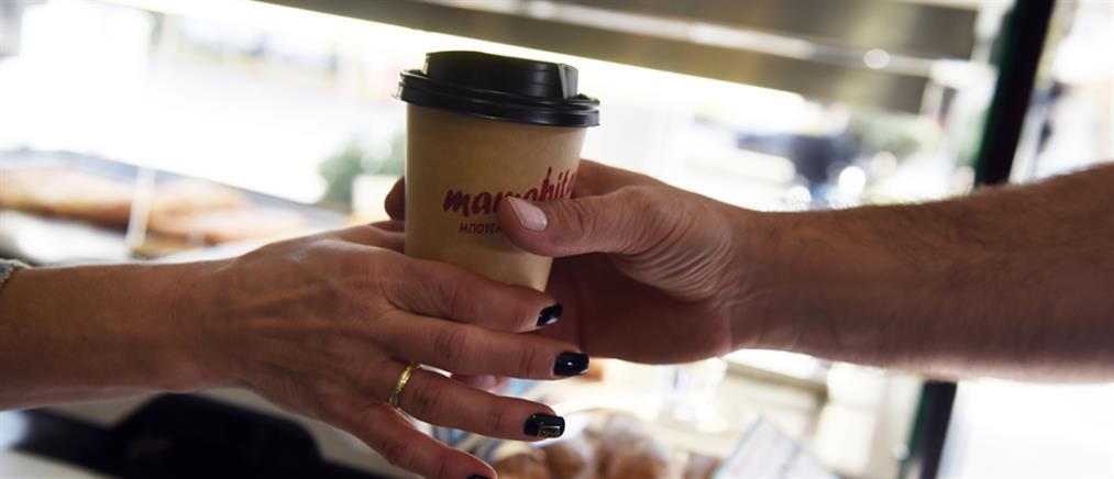 Ένα χέρι δίνει καφέ σε ένα άλλο.